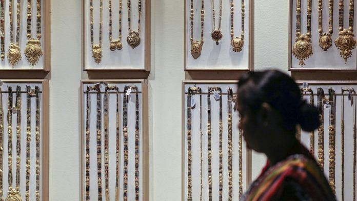 Gold necklaces hang on display at jewelry store in Pune | Dhiraj Singh/Bloomberg