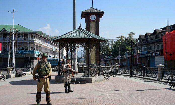 Security personnel guard during the strike call given by separatist leaders against urban local bodies elections, at Lal Chowk in Srinagar