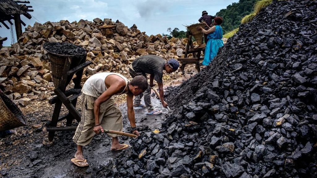 Daily wage laborers shovel coal into baskets at a limestone quarry in Lower Cherrapunji in Meghalaya| Sanjit Das/Bloomberg