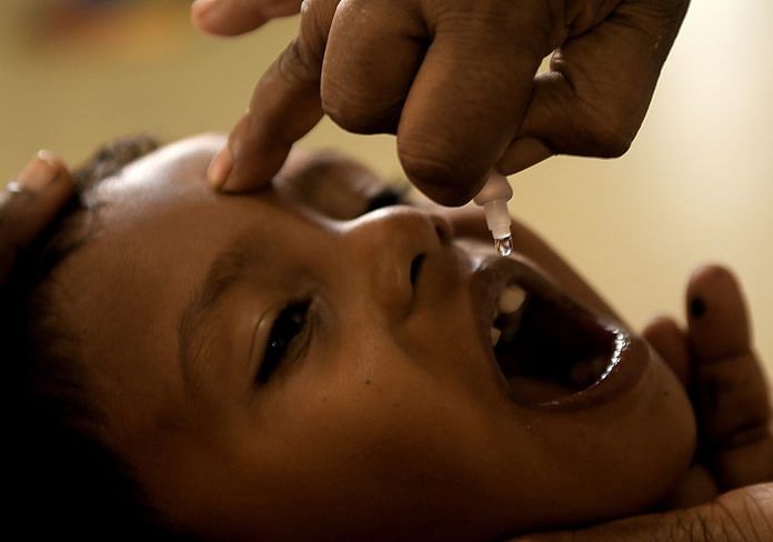 A child receives polio vaccine drops at a goverment hospital | Arun Sankar/AFP/Getty Images