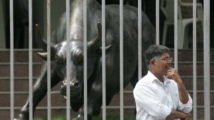 A man checks out the live index outside the Bombay Stock Exchange | Getty Images