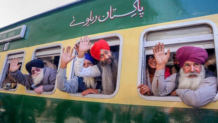 Sikh pilgrims wave from a special train as they leave for Pakistan to visit Nankana Sahib for celebrating 550th birthday anniversary of Guru Nanak | PTI