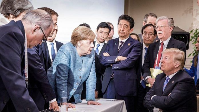 Angela Merkel , German Chancellor, deliberates with US president Donald Trump on the sidelines of the official agenda on the second day of the G7 summit |