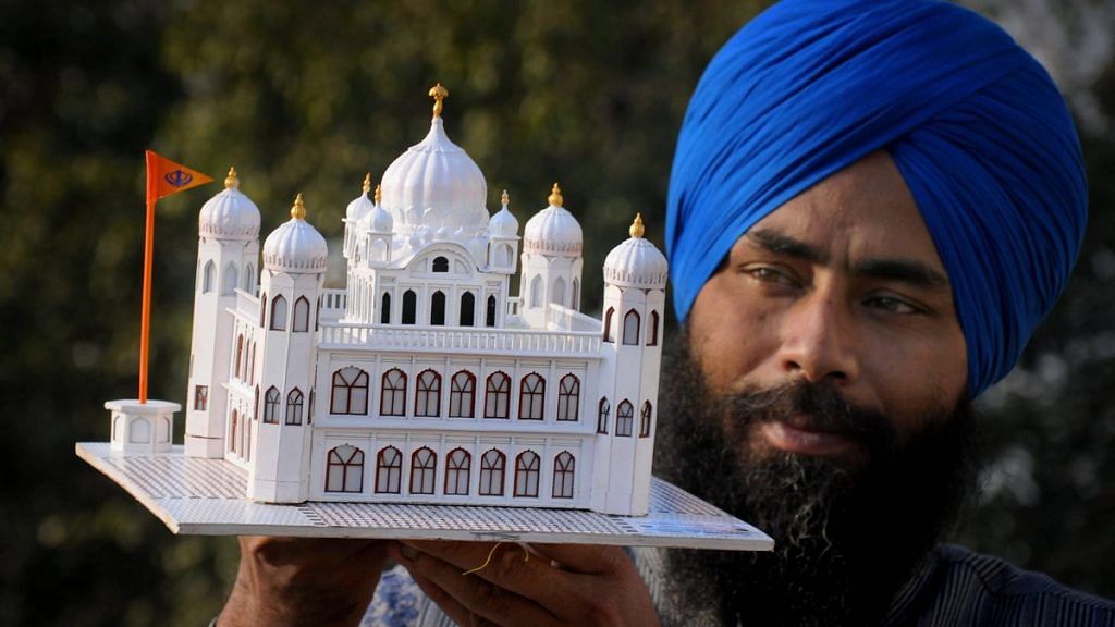 Artist Gurpreet Singh shows his paper model of Kartarpur Sahib gurdwara | PTI