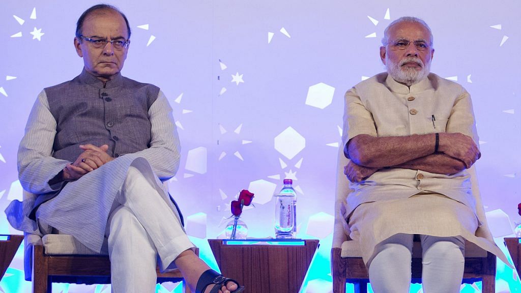 Arun Jaitley and Narendra Modi at a conference in New Delhi | Kuni Takahashi/Bloomberg