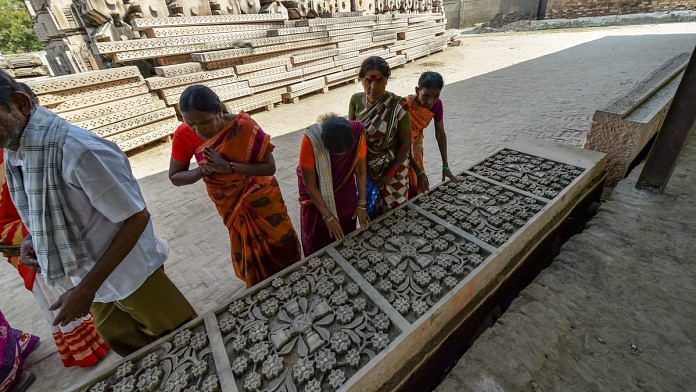 Visitors look at chiseled slabs of stone for a Ram temple at Kar Sevak Puram workshop in Ayodhya | Arun Sharma/PTI