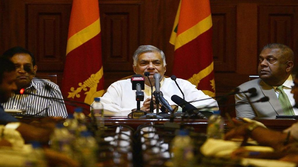 Sri Lankan Prime minister Ranil Wickremesinghe (C) takes part in a press conference in Colombo | Getty Images