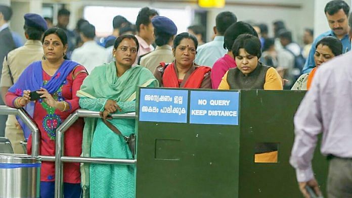 Women's rights activist Trupti Desai (R) and other women pilgrims wait at the Cochin International Airport after protesters blocked the arrival gate of the domestic terminal