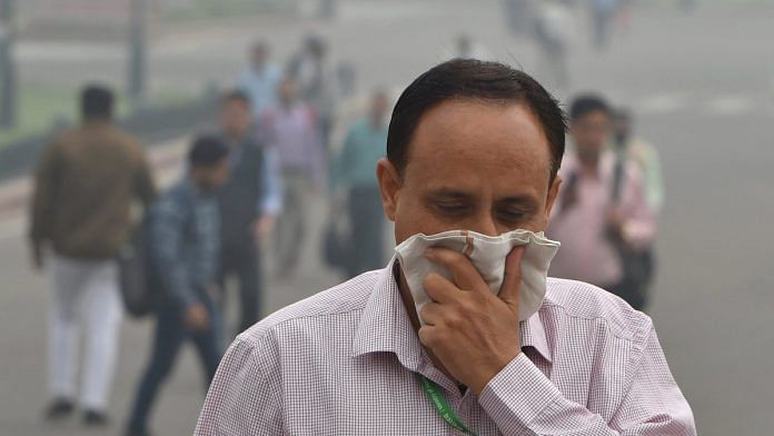 A pedestrian covers his face with a handkerchief for protection against air pollution in New Delhi | Shahbaz Khan/PTI