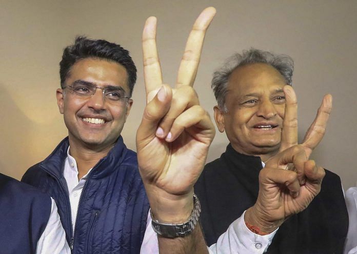 Congress leaders Ashok Gehlot (R) and Sachin Pilot (C) flash victory signs after the declaration of Rajasthan Assembly election result | PTI