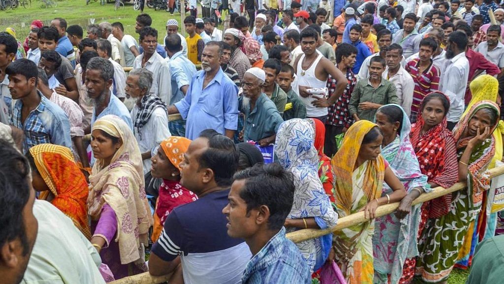 People wait to check their names on the final draft of the Assam's National Register of Citizens