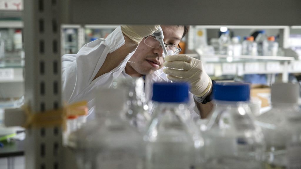 A researcher prepares a sample inside a laboratory in China |