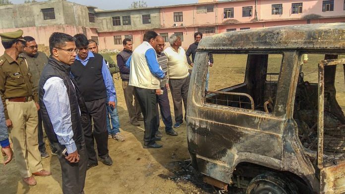 Policemen inspect vehicles set on fire by a mob during a protest in Bulandshahr | PTI