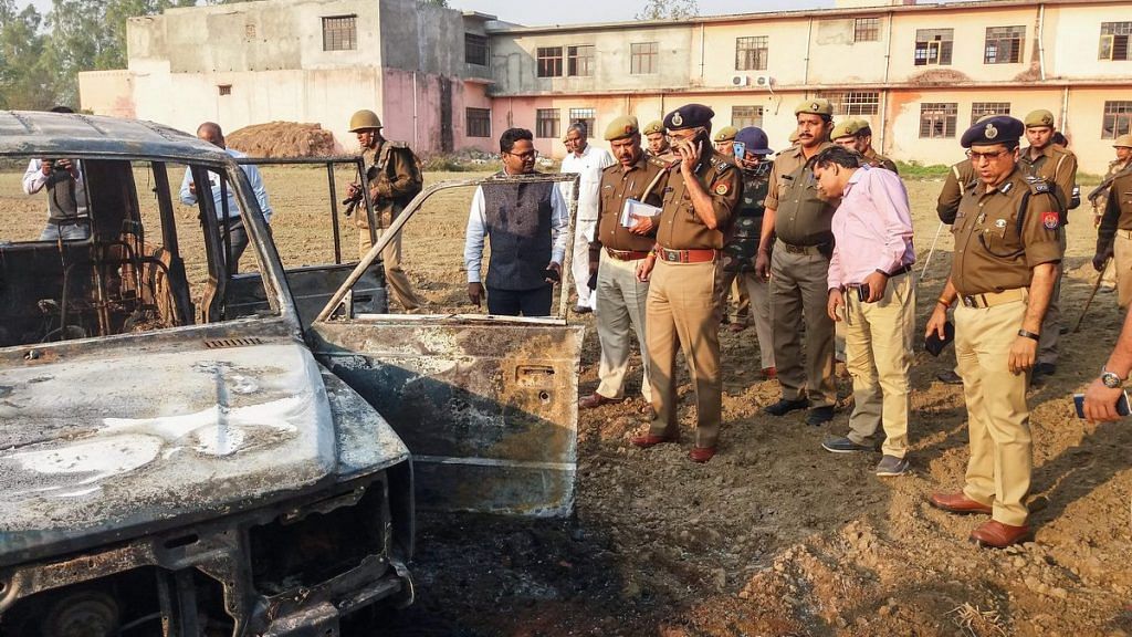 Policemen inspect after several vehicles were set on fire by a mob in Bulandshahr | PTI
