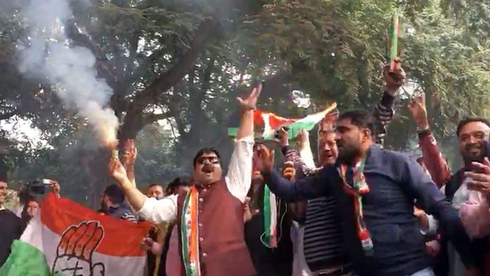 Congress workers celebrate outside party headquarters in New Delhi | Shahbaz Ansar/ThePrint