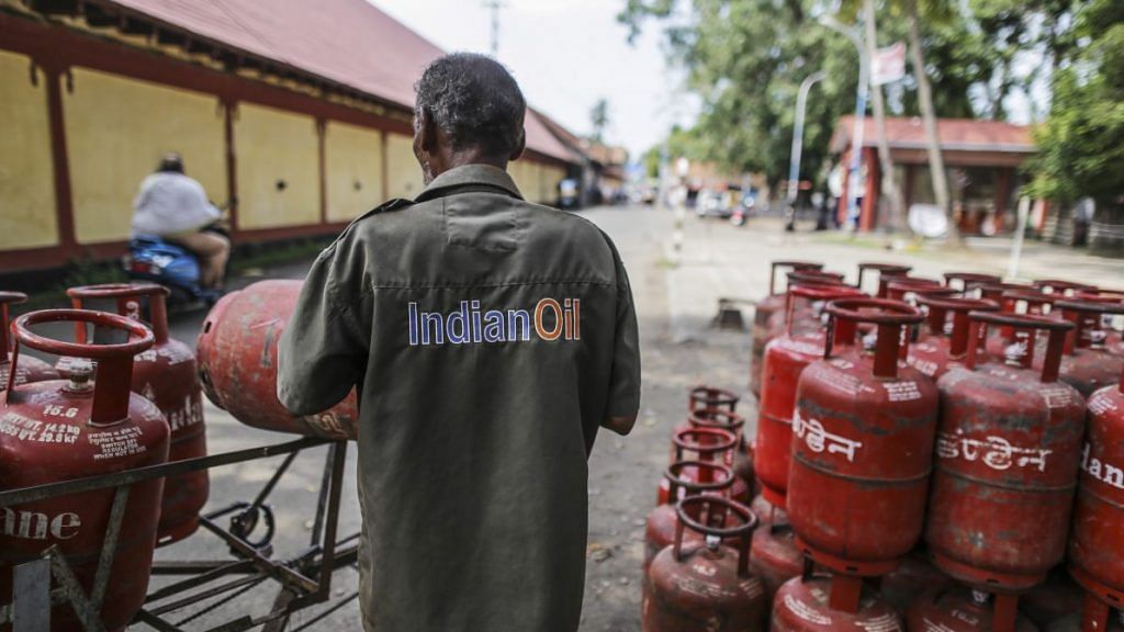 An Indian Oil Corp. employee loads LPG cylinders onto his vehicle in Cochin | Dhiraj Singh/Bloomberg