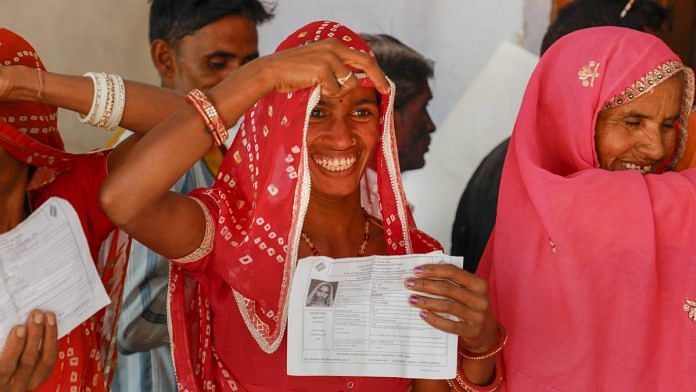 A voter showing her identity card during the Rajasthan assembly elections