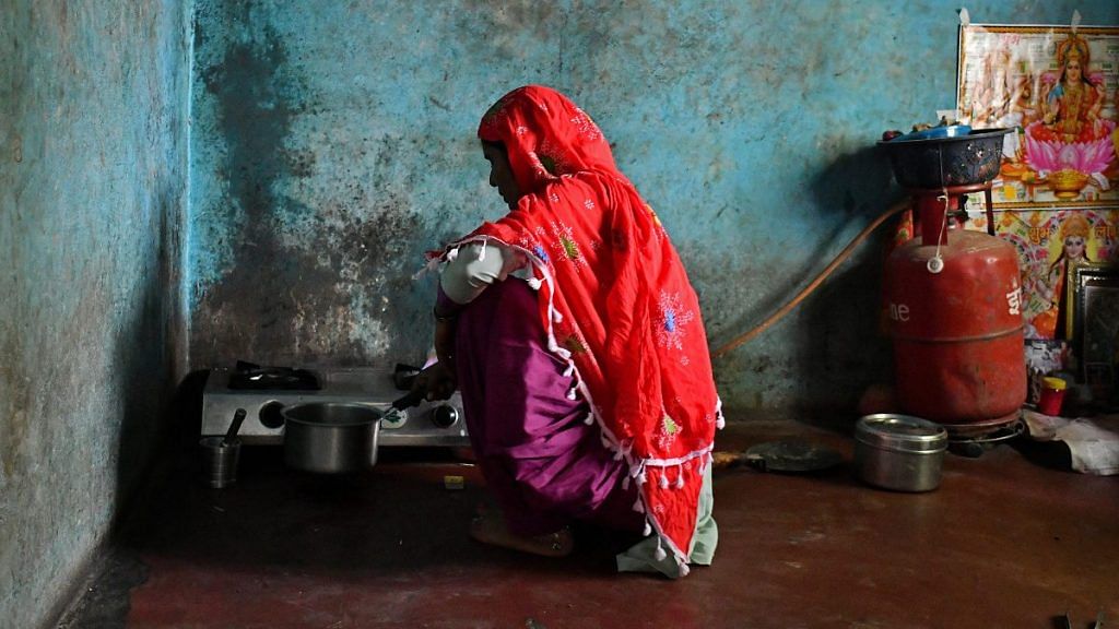 A woman in Uttar Pradesh cooks on LPG-connected oven | Anindito Mukherjee | Bloomberg