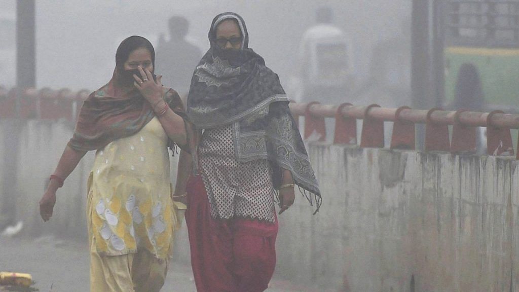 Women try to protect themselves from heavy smog and air pollution | PTI