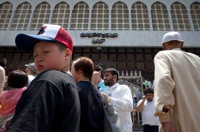 Some tourists and members of Hong Kong's Muslim community outside the Kowloon Mosque and Islamic Center in Tsim Sha Tsui, Hong Kong