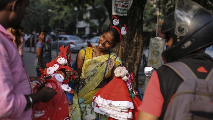 A roadside vendor sells festive Christmas hats and hairbands in Mumbai