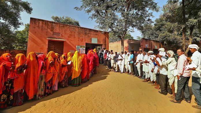 Voters stand in queues outside a polling station in Jaipur | PTI