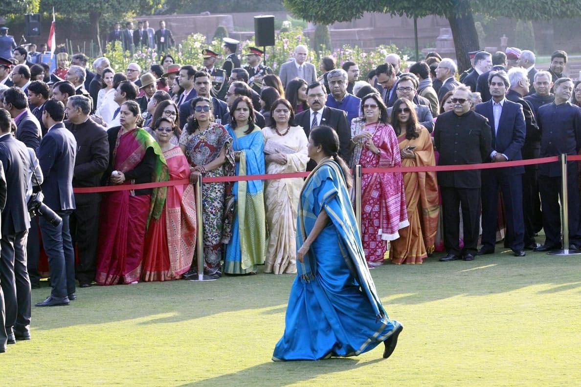 Defence minister Nirmala Sitharaman walks across the lawn as guests look on | Praveen Jain/ThePrint