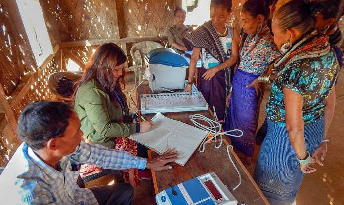 Electoral officials demonstrate how to use an EVM at refugee camp in Tripura | PTIElectoral officials demonstrate how to use an EVM at refugee camp in Tripura | PTI