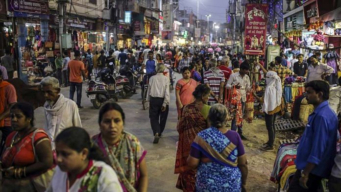 Pedestrians and shoppers walk past stores on a street in Varanasi (representational image)