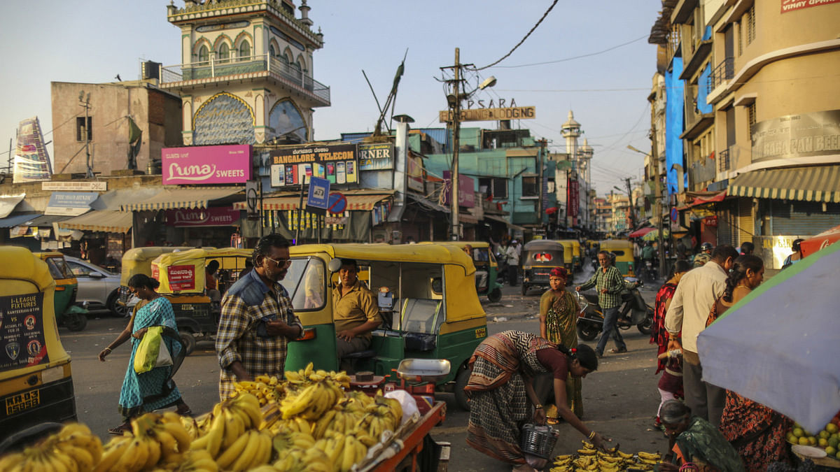 A customer looks at banana displayed for sale at a roadside fruit stall in Bangalore, India | Dhiraj Singh/Bloomberg