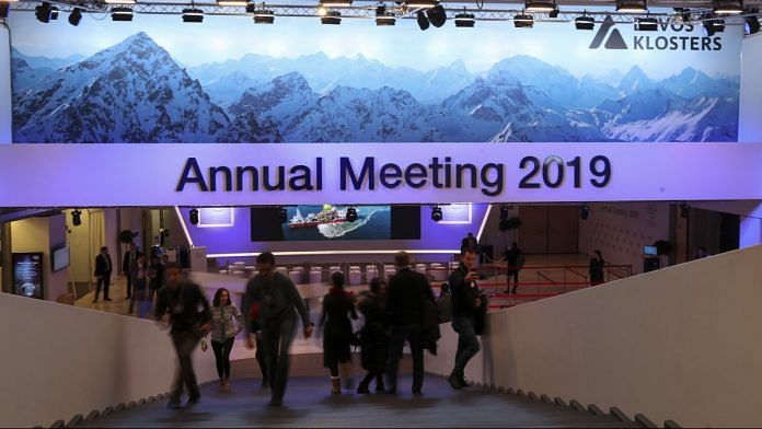Visitors and workers walk inside the Congress Center ahead of the World Economic Forum in Davos | Simon Dawson/Bloomberg