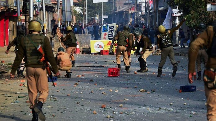 Police and CRPF personnel in action against stone-pelting protesters