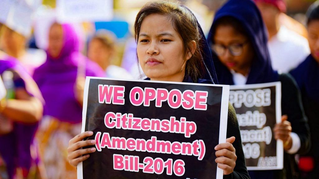 A girl holds placard during a protest against citizenship Act