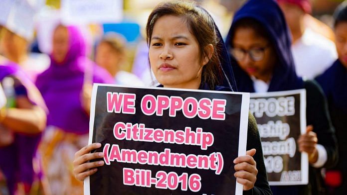 A girl holds placard during a protest against citizenship Act
