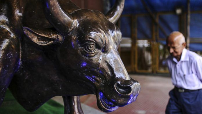 A bronze bull statue stands at the entrance to the Bombay Stock Exchange (BSE) building in Mumbai