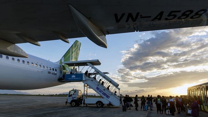Passengers disembark a Bamboo Airways airplane at Phu Cat Airport in Qui Nhon, Vietnam