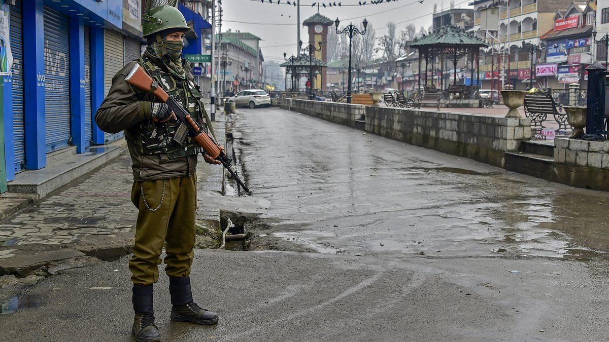 A security personnel stands guard at Lal Chowk during a two-day strike call given by separatist leaders to protest against the legal challenge to Article 35-A and Article 370 of the Constitution, which grant special privileges to Jammu and Kashmir, in Srinagar, on 13 February, 2019 | Photo: S Irfan | PTI