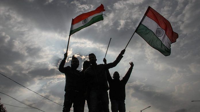 Protestors holding Tricolor raise slogans during a demonstration against the Pulwama terror attack