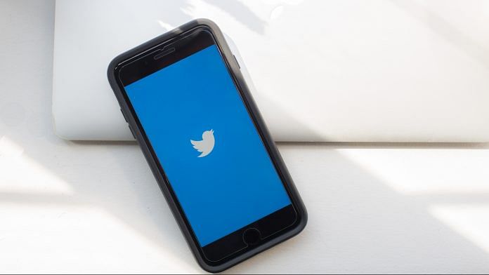 Twitter logo displayed on a phone | Alex Flynn/Bloomberg