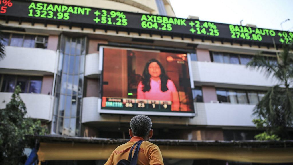 A man stands outside the Bombay Stock Exchange building in Mumbai | Dhiraj Singh/Bloomberg