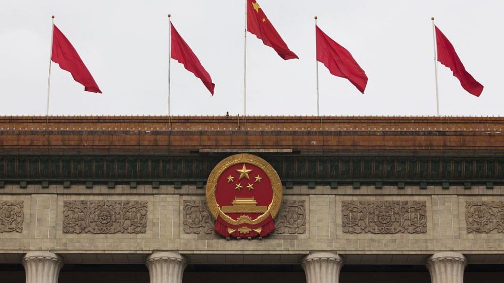 The Chinese national emblem and flags are displayed above the Great Hall of the People in Beijing, China (representational image) | Photo: Giulia Marchi | Bloomberg