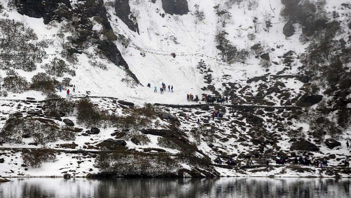 People gather on a mountain at Tsongmo Lake near to the Nathula Pass, an open trading post in the Himalayas between India and China