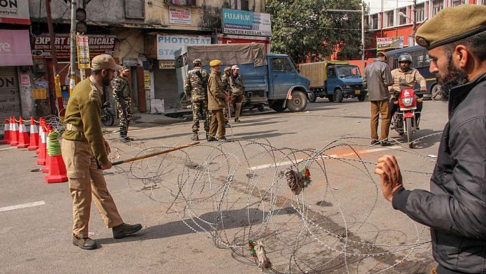 Army personnel stand guard during the 4th consecutive day of the curfew in Jammu