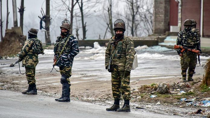 Security personnel stand guard at the site of suicide bomb attack at Lethpora area, in Pulwama district of south Kashmir