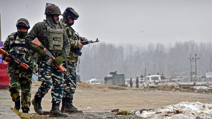 Security personnel inspect the site of suicide bomb attack at Lethpora area, in Pulwama, Friday | PTI