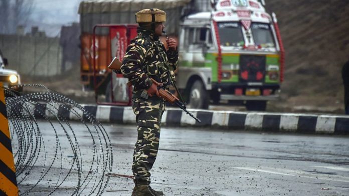 A CRPF soldier stands guard near the site of suicide bomb attack at Lathepora Awantipora in Pulwama | S Irfan | PTI File photo