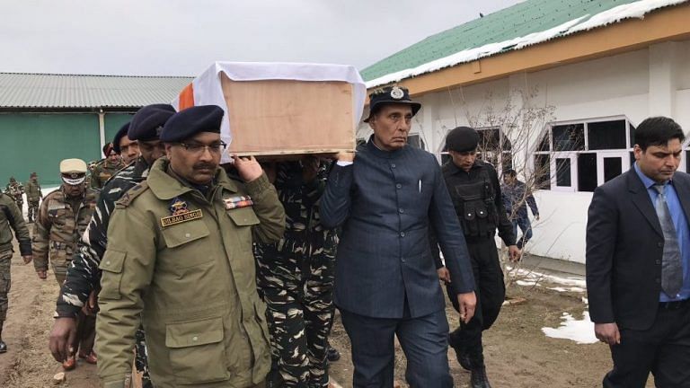 Home minister Rajnath Singh lends his shoulder to the coffin of dead CRPF jawan