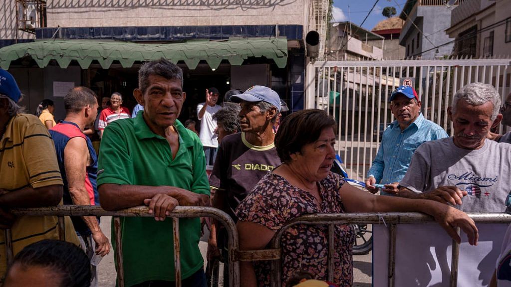 Residents stand in line at a volunteer humanitarian aid camp set up for medical treatments in the Macarao neighborhood of Caracas, Venezuela | Adriana Loureiro Fernandez/Bloomberg