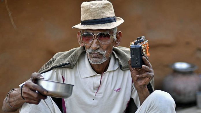 A man listens to the radio at a home in Rajasthan