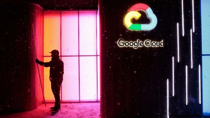 A worker stands by a Google Inc. 'Google Cloud' pop-up space in Davos, Switzerland| Jason Alden/Bloomberg